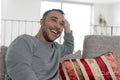 Smiling mature man relaxing on sofa at home