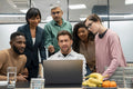 Business people using laptop in office