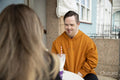 Man and woman sitting at table in sidewalk cafe