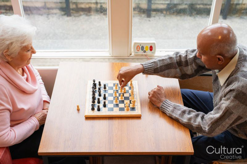 Senior people playing chess in nursing home