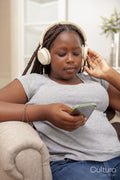 Girl sitting on sofa and listening to music