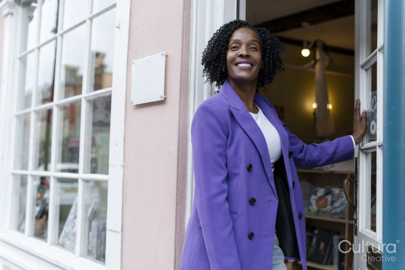 Portrait of female business owner walking into store