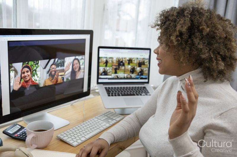 Smiling woman having video conference at home