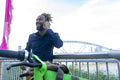Businessman standing by rental bicycle and talking on phone