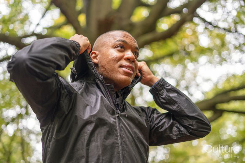 Man wearing rain jacket in forest