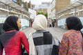 Rear view of young women wearing hijabs walking in city