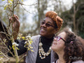 Mother and daughter looking at blossoms