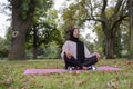 Woman in hijab meditating in park