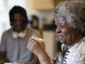 Smiling woman holding cup at home