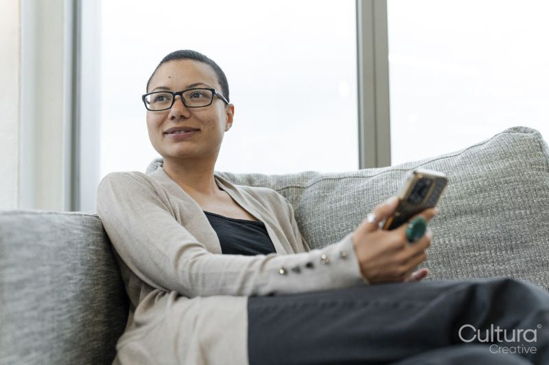 Non binary person resting in office lobby