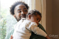 Father holding baby daughter