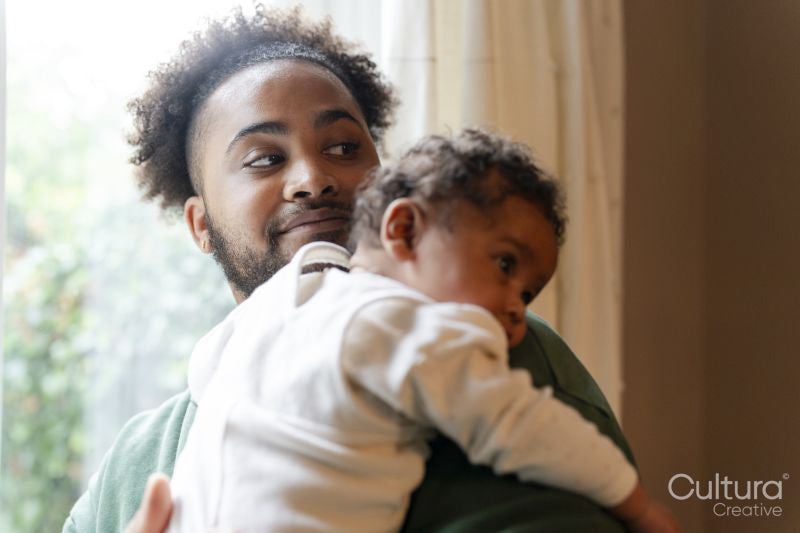 Father holding baby daughter