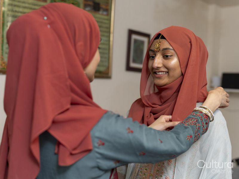 Smiling women preparing for Ramadan celebration at home