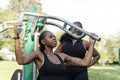 Young female friends working out in outdoor gym