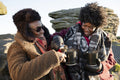 Two senior women enjoying hot drink in nature