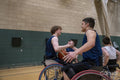 Men in wheelchairs shaking hands after match