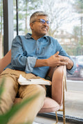 Smiling mature businessman sitting in chair in office