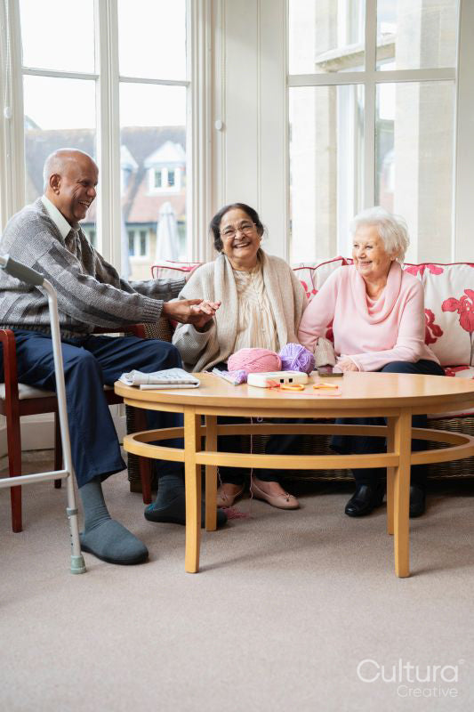 Cheerful senior people relaxing in common room at nursing home