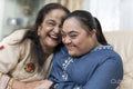 Portrait of grandmother and granddaughter in living room
