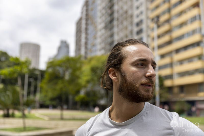 Brazil, Sao Paulo, Smiling athletic man standing in city