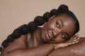 Studio shot of smiling young woman with braided hair