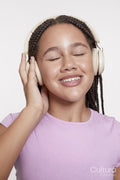 Studio portrait of smiling girl with headphones and eyes closed