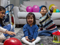 Smiling siblings playing at home