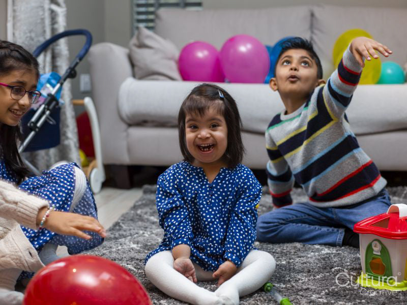 Smiling siblings playing at home