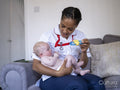 Nurse playing with baby girl