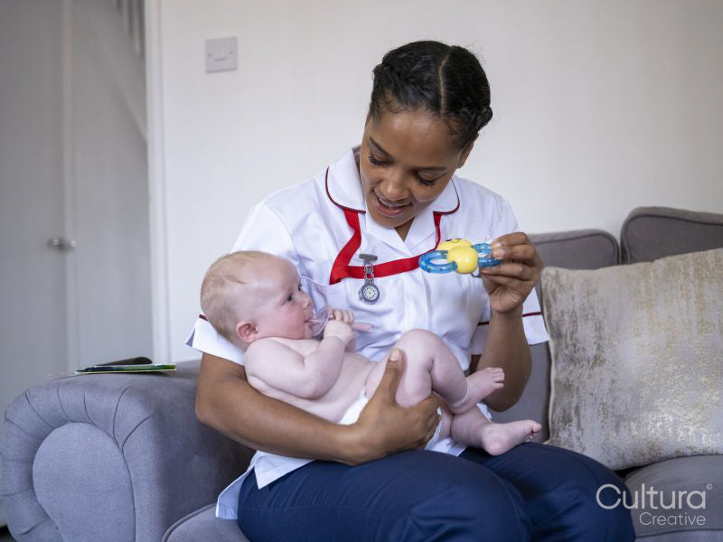 Nurse playing with baby girl