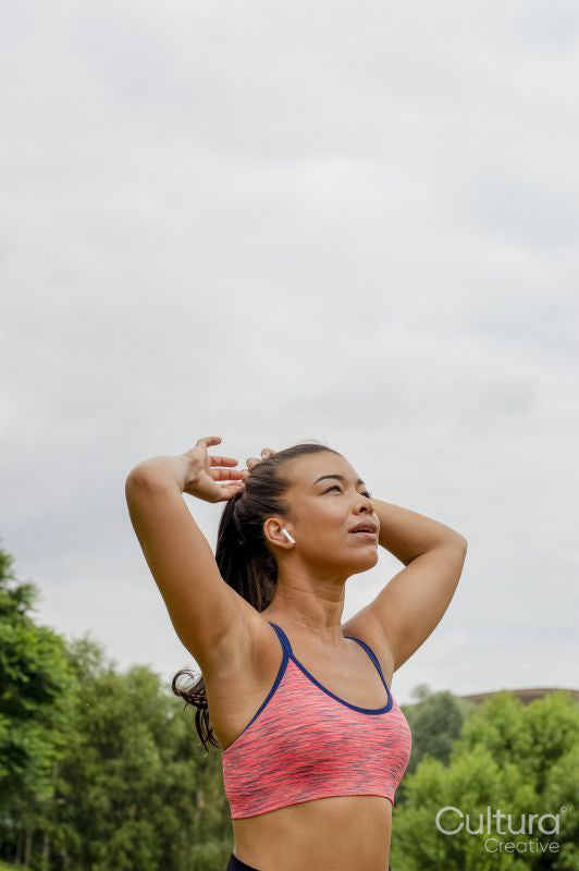 Portrait of woman tying hair before training