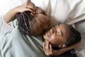 Directly above view of couple sleeping on carpet