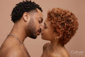 Studio portrait of happy young couple kissing