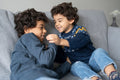 Brothers relaxing on sofa at home