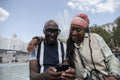 Happy mature couple posing next to fountain in Trafalgar Square