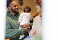 Smiling parents with baby daughter at home