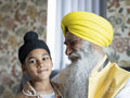 Smiling grandfather and grandson in traditional clothing