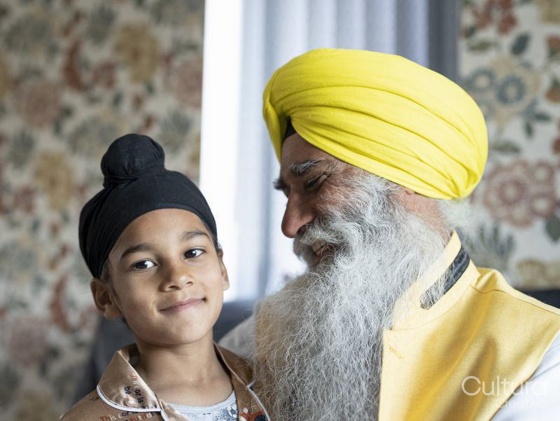 Smiling grandfather and grandson in traditional clothing