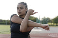 Female athlete stretching arms before training