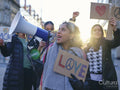 Activists holding peace signs protesting in street