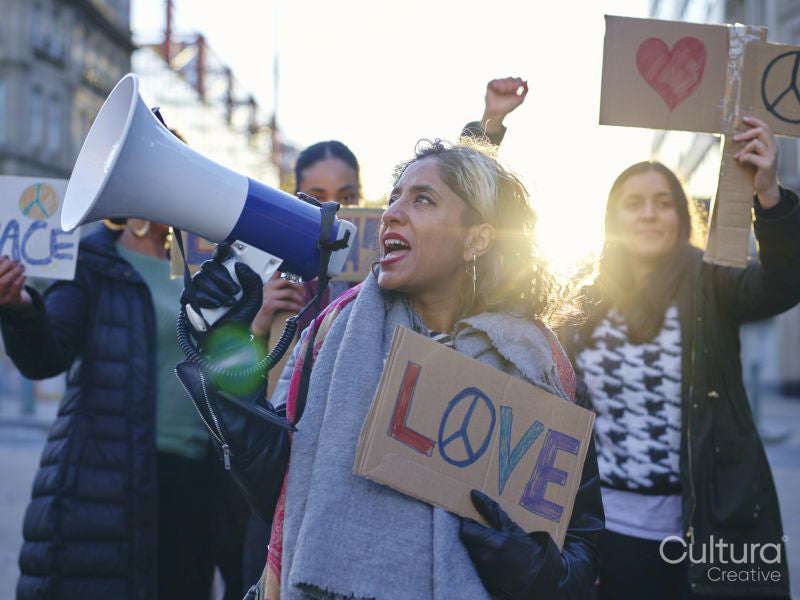 Activists holding peace signs protesting in street