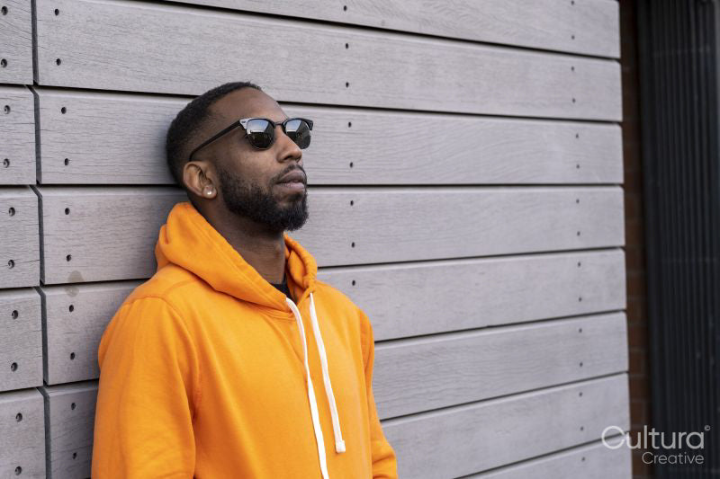 South Yorkshire, Man in yellow hooded shirt leaning against wall