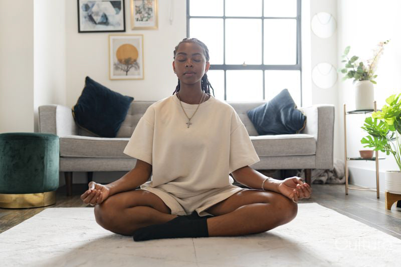 Young woman practicing yoga at home