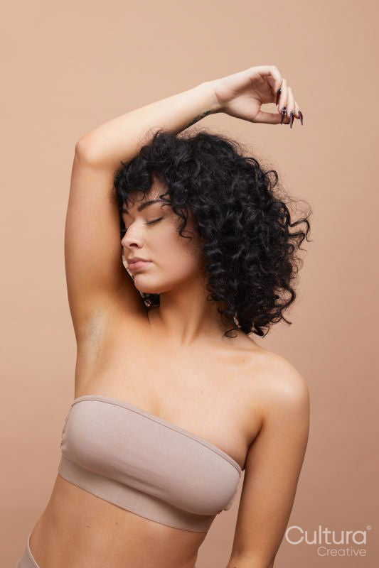 Studio portrait of beautiful serious woman wearing strapless bra
