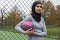 Portrait of woman in hijab holding basketball ball
