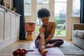 Young woman stretching at home
