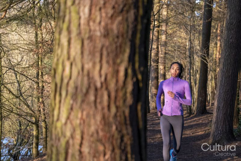 Young woman jogging in forest