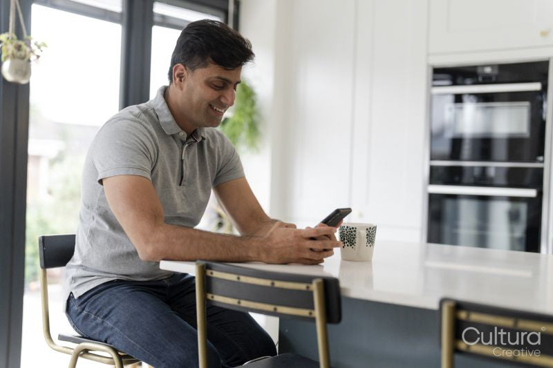 Man using phone while sitting at table