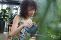 Woman watering plants at home