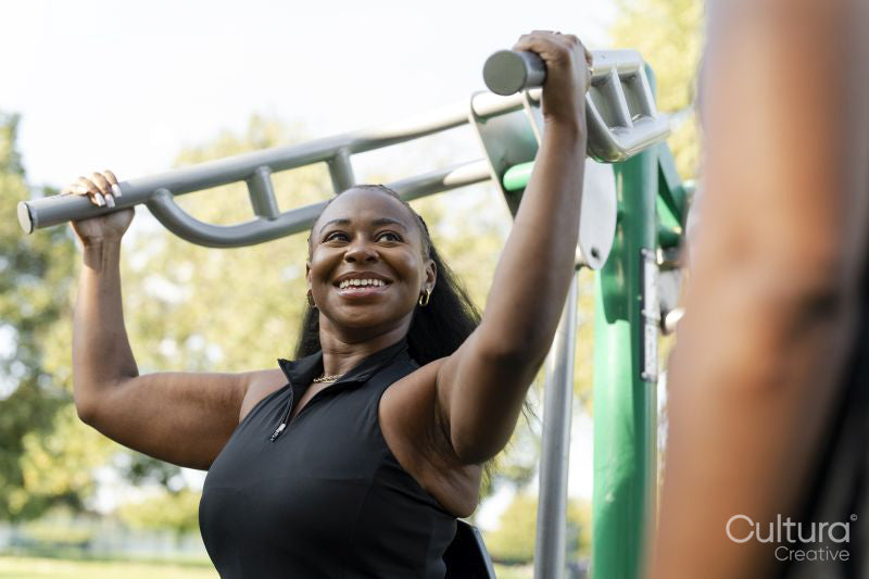 Young women exercising in outdoor gym